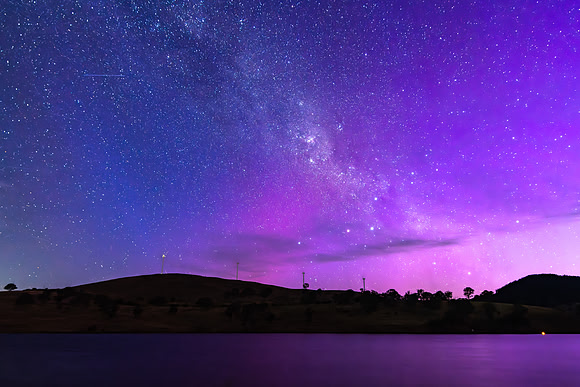A Pink Aurora Australis and the Milky Way Shimmers Over the Dam