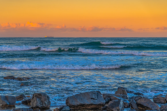 Sunset at the Seaside with black rocks