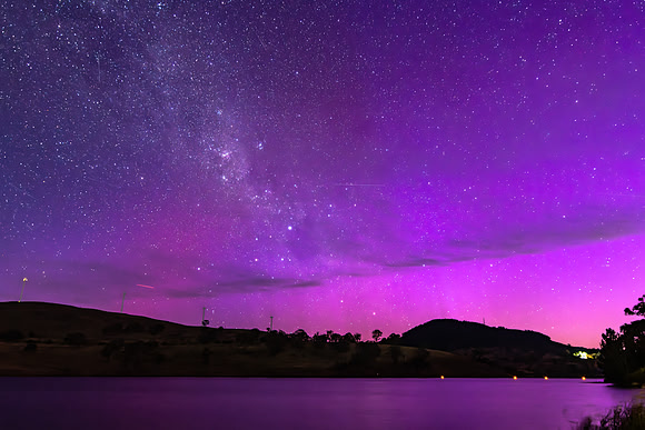 A Pink Aurora Australis and the Milky Way Shimmers Over the Dam