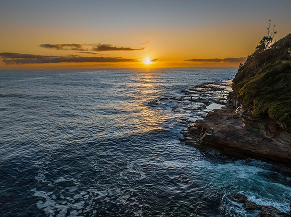 Sunrise over the ocean with rocks