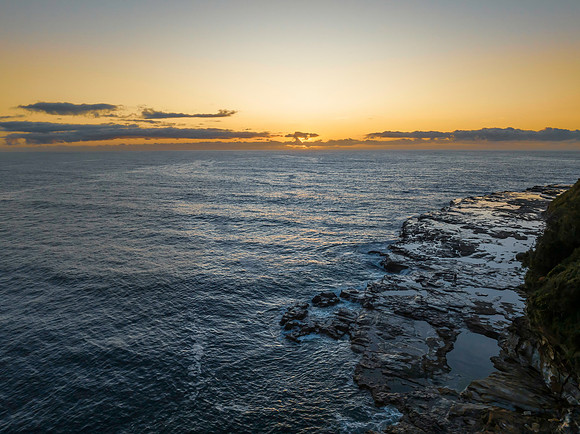 Sunrise over the ocean with rocks