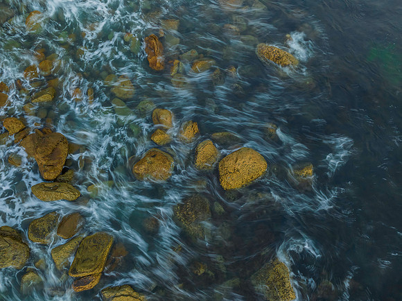 Top down early morning light over the rocks and sea