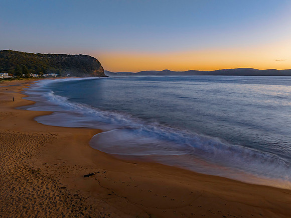 Aerial sunrise seascape with calm seas and a clear sky