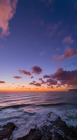 Surfs up sunrise at the seaside with scattered clouds