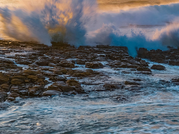 Splashes and waves on the rock platform
