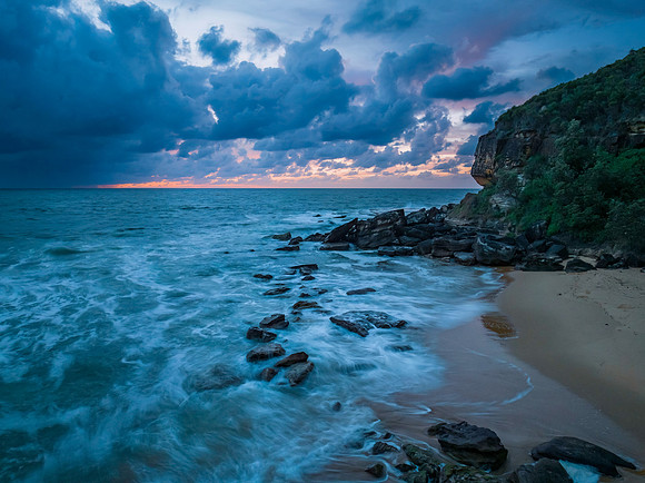 Rain clouds and sunrise at the beach