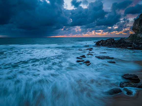 Rain clouds and sunrise at the beach