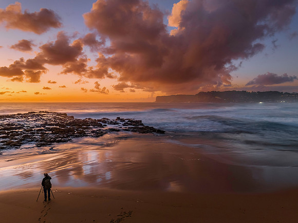 Surfs up sunrise at the seaside with scattered clouds