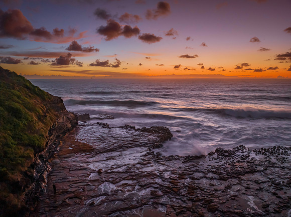 Surfs up sunrise at the seaside with scattered clouds
