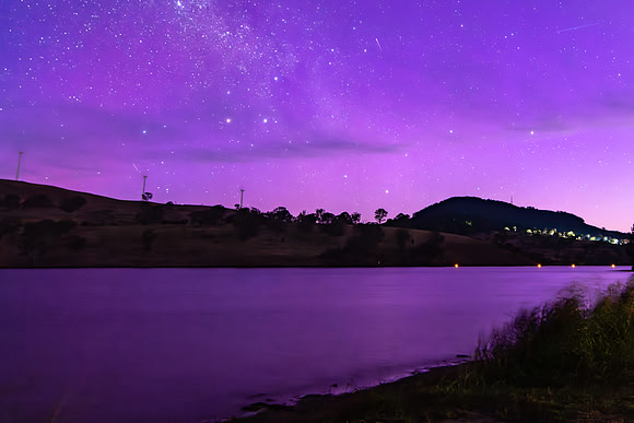 A Pink Aurora Australis and the Milky Way Shimmers Over the Dam