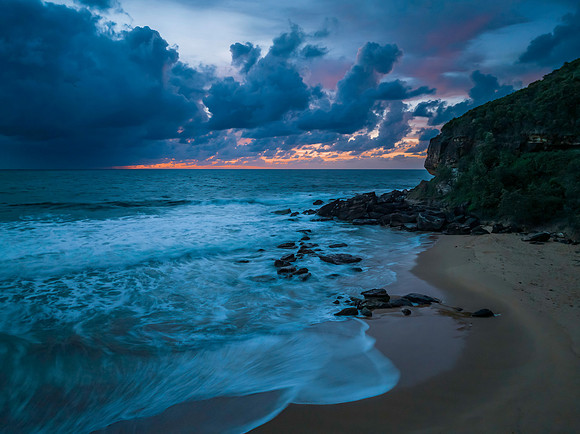 Rain clouds and sunrise at the beach