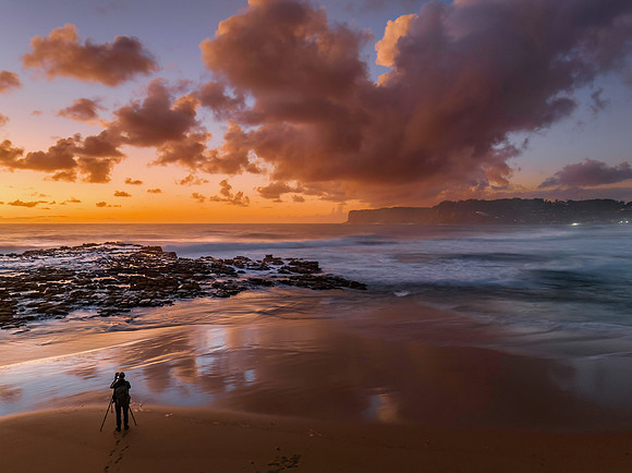 Surfs up sunrise at the seaside with scattered clouds