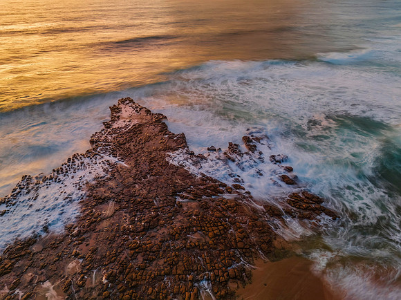 Surfs up sunrise at the seaside with scattered clouds
