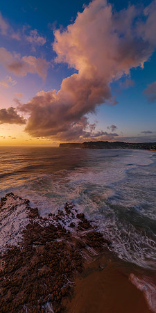 Surfs up sunrise at the seaside with scattered clouds