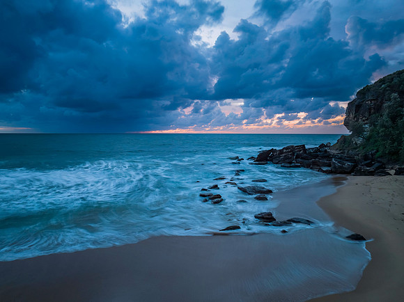 Rain clouds and sunrise at the beach