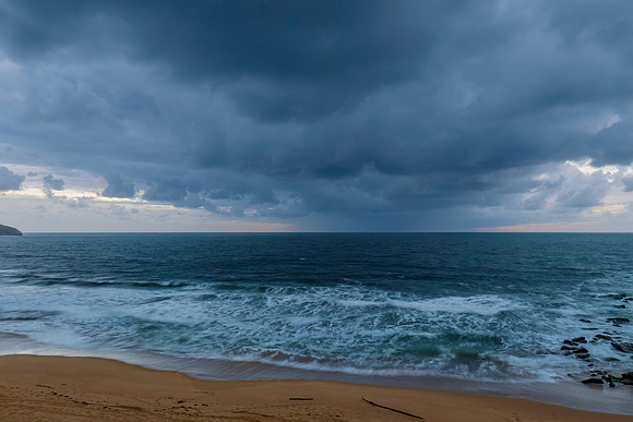 Rain clouds and sunrise at the beach