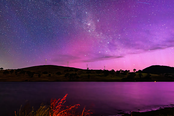 A Pink Aurora Australis and the Milky Way Shimmers Over the Dam