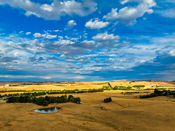 Cloud‑Laced Skies at Golden Hour Over Farmland