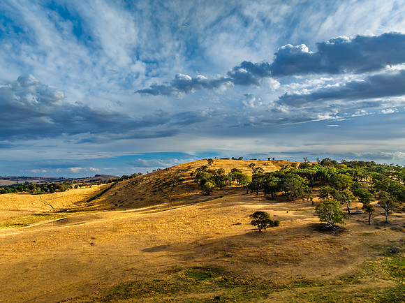 Cloud‑Laced Skies at Golden Hour Over Farmland