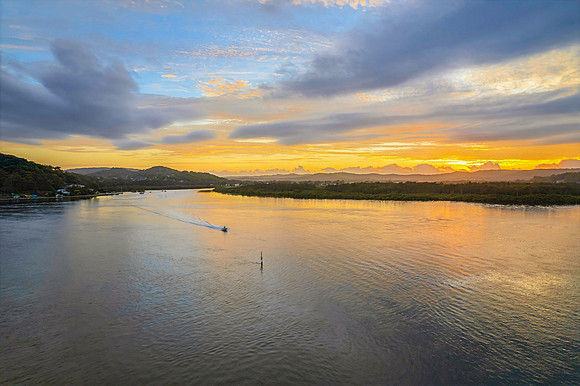 Sunrise waterscape with a mix of low, medium and high clouds