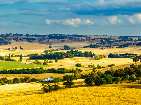 Cloud‑Laced Skies at Golden Hour Over Farmland