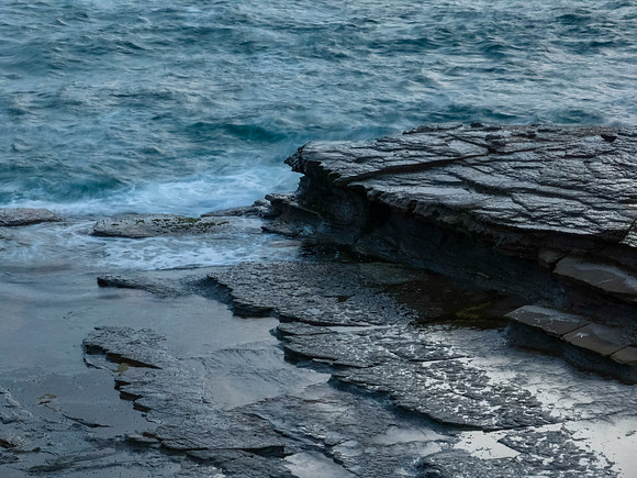 Sunrise light on the sea and rocky coastline