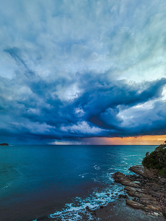 Rain clouds and storm light sunrise seascape