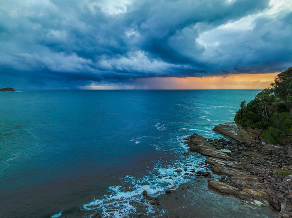 Rain clouds and storm light sunrise seascape