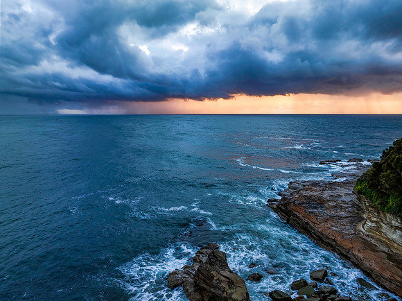 Rain clouds and storm light sunrise seascape