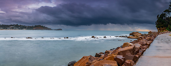Sunrise seascape panorama with rain clouds