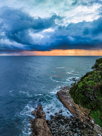 Rain clouds and storm light sunrise seascape