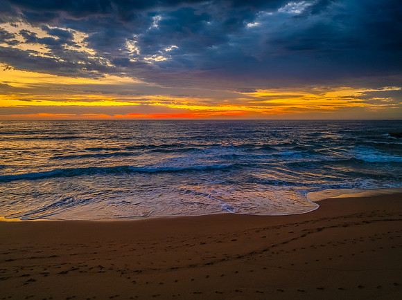 Pretty Sunrise at the seaside with rain clouds