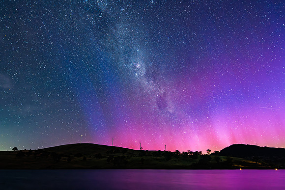 A Pink Aurora Australis and the Milky Way Shimmers Over the Dam