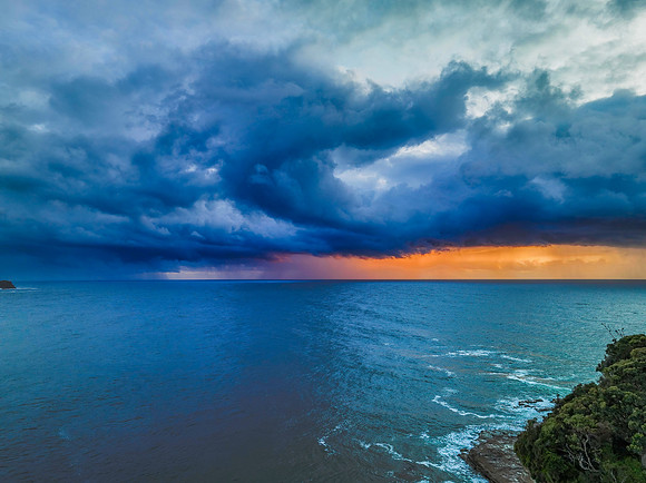 Rain clouds and storm light sunrise seascape