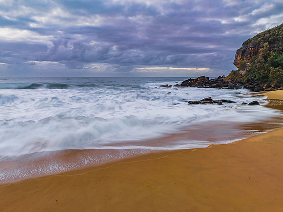 Sunrise and a cloud covered sky at the beach