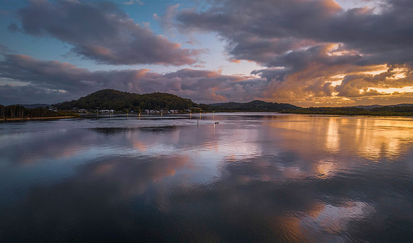 Sunrise over the bay with clouds and reflections