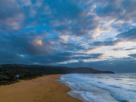 Sunrise and a cloud covered sky at the beach