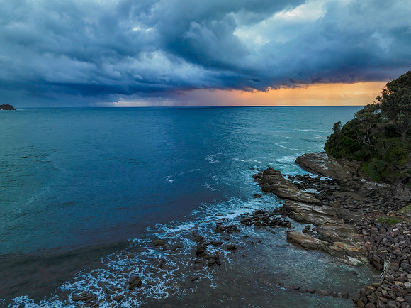 Rain clouds and storm light sunrise seascape