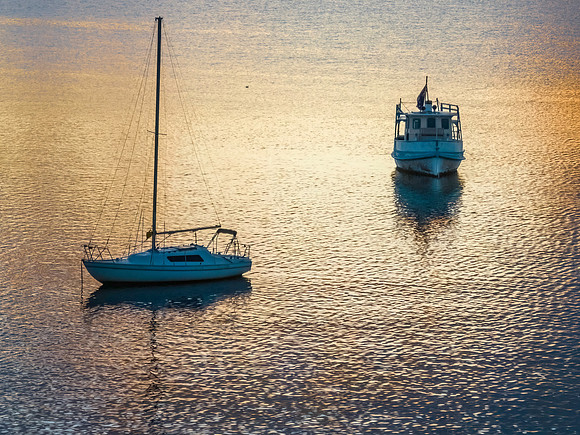 Aerial sunrise waterscape with boats and beautiful light