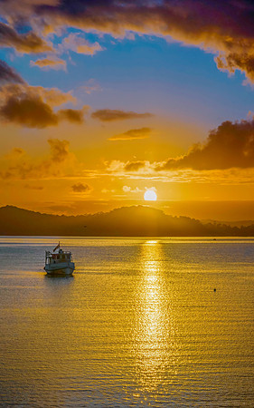 Aerial sunrise waterscape with boats, clouds and reflections