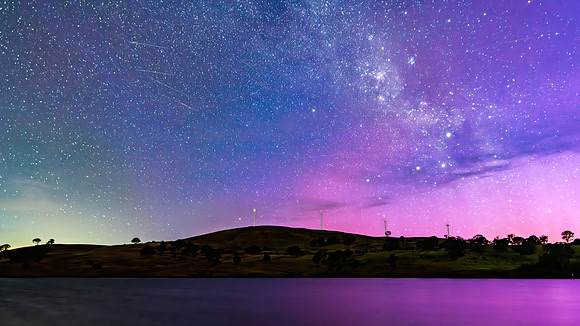 A Pink Aurora Australis and the Milky Way Shimmers Over the Dam