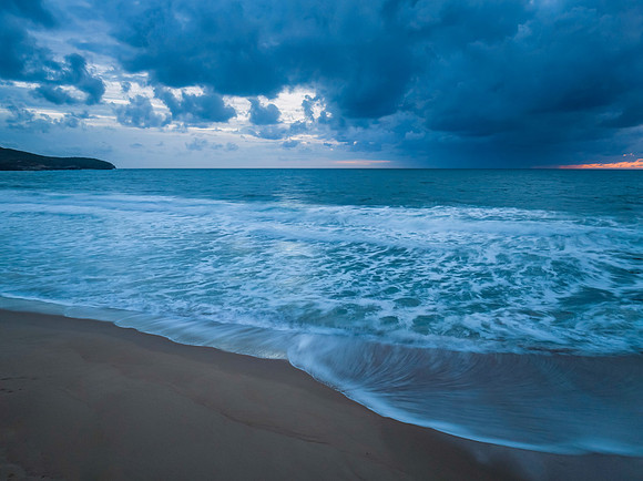 Rain clouds and sunrise at the beach