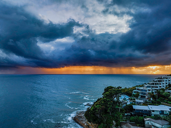 Rain clouds and storm light sunrise seascape