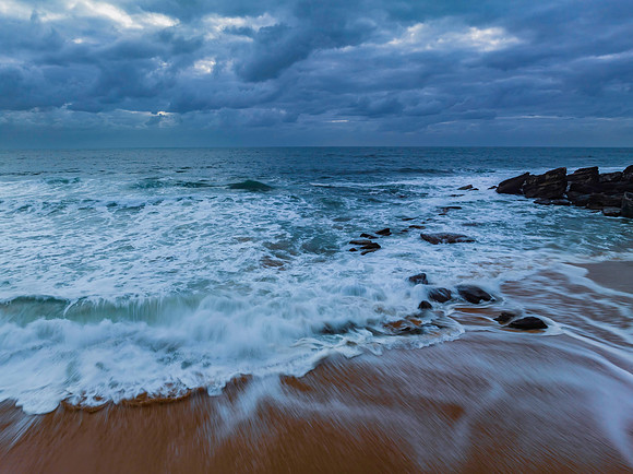 Sunrise and a cloud covered sky at the beach