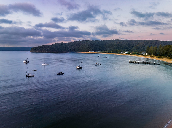 Sunrise views over the bay with boats and mountain ranges from P