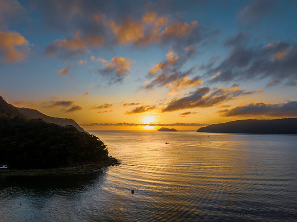 Sunrise views over the bay with boats and mountain ranges from P