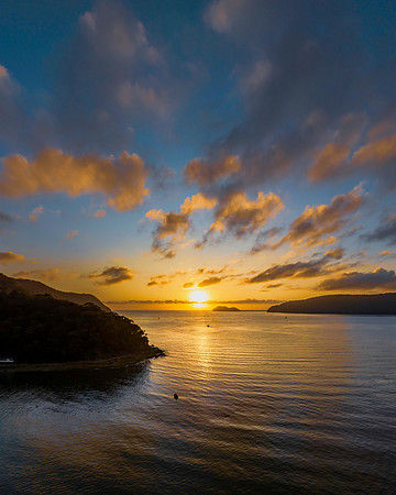 Sunrise views over the bay with boats and mountain ranges from P