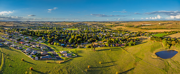 Golden hour light over the rural landscape with clouds