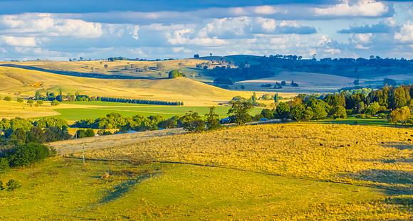 Golden hour light over the rural landscape with clouds