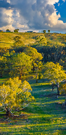 Golden hour light over the rural landscape with clouds